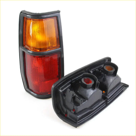 Black plastic tail light assembly with amber and red lenses for nissan datsun 720 ute 1982-1986 back side view
