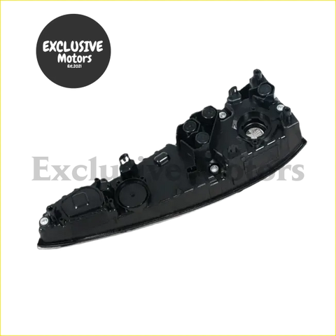 Black plastic headlight housing with multiple mounting points and circular cutouts for toyota prius tail lights back side