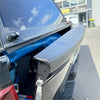 Black textured truck bed cover for nissan navara 2021 plus with sleek durable design shown from back side