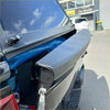 Black textured tailgate cover with matte finish and integrated handle for nissan navara 2021 back side view