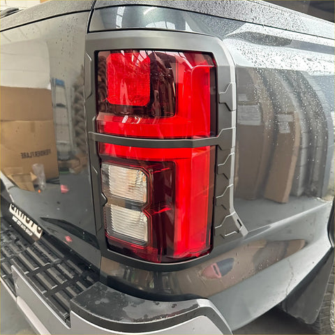 Black matte taillight cover for mitsubishi triton 2024 with red and clear lens in rugged gray plastic bezel back side view