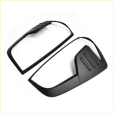 Black matte-finish side mirror cover trim for nissan navara 2021 plus st st-x pro 4x4 shown from the back side