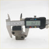 A black digital caliper measures a gray textured metal tensioner guide chain for datsun nissan 521 620 621 320 410 411