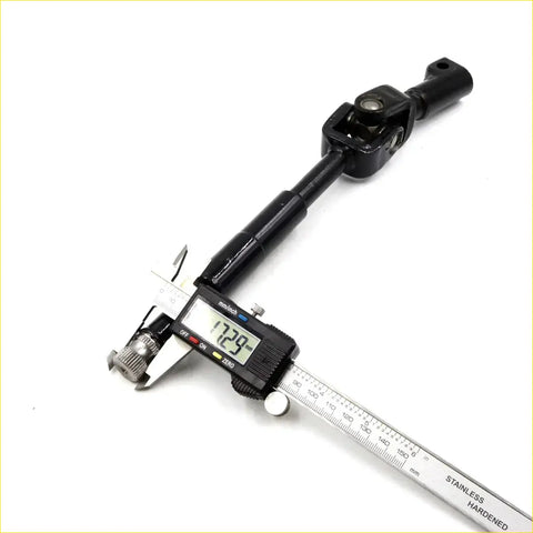 Black metal u-joint steering shaft for toyota hilux 2004-2015 being measured with digital caliper