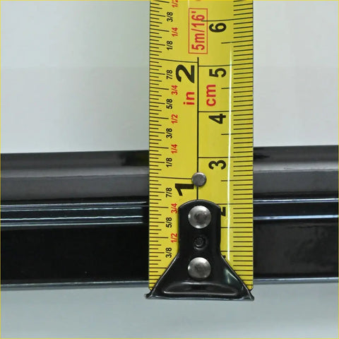 Yellow tape measure with black metal clip and silver rivets showing inches and centimeters for nissan pathfinder terrano windshield moulding set 1986-1995