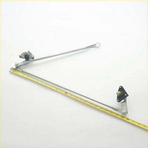 Silver metal windshield wiper linkage arm with black mounting brackets and white spherical ends for nissan sentra b13